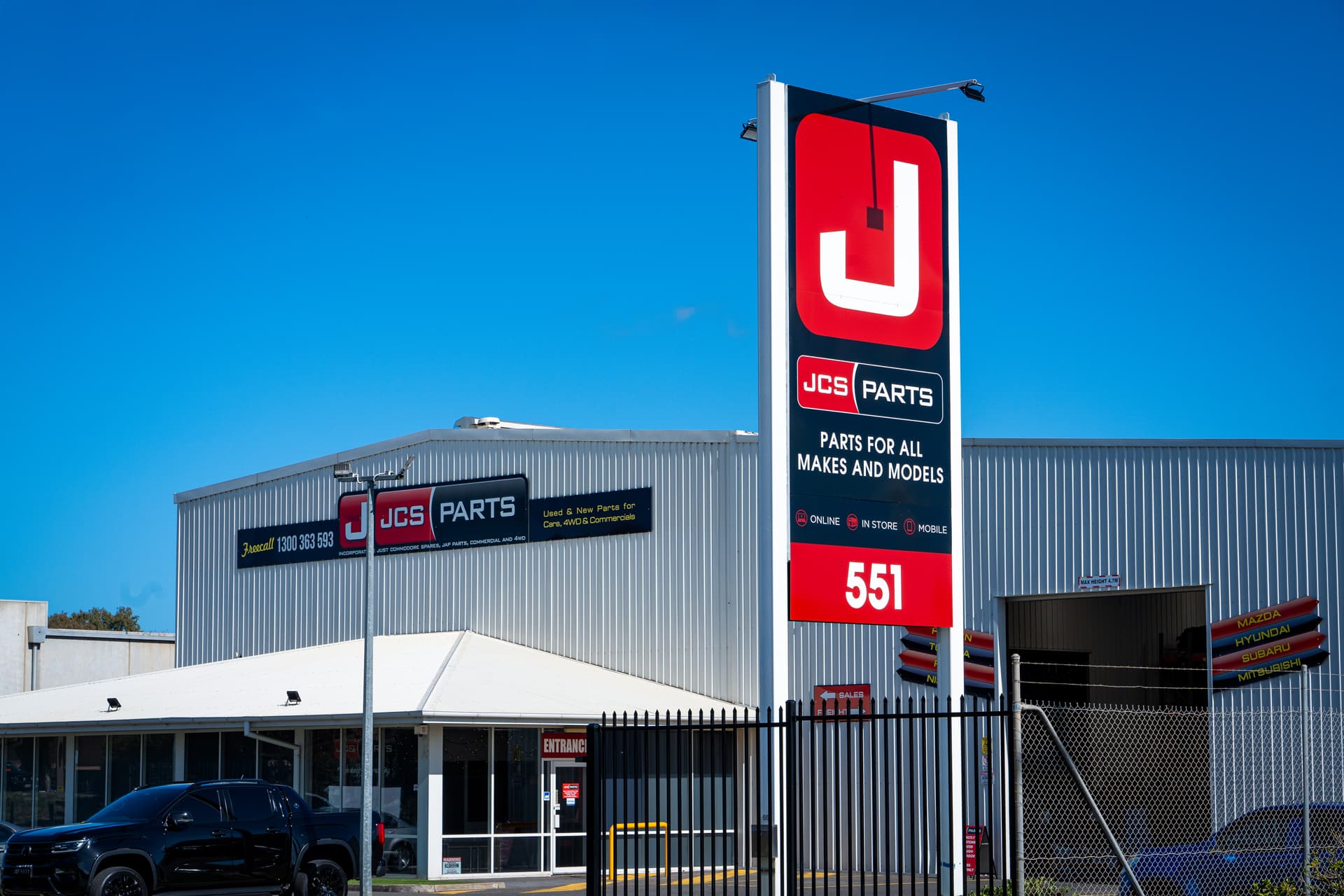 JCS Parts building with a large sign in front on a clear day