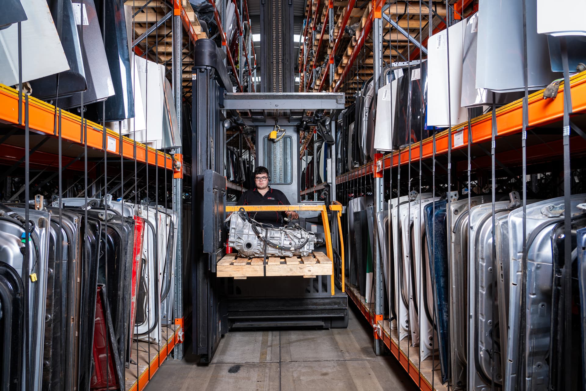jcs parts worker in forklift getting part in warehouse